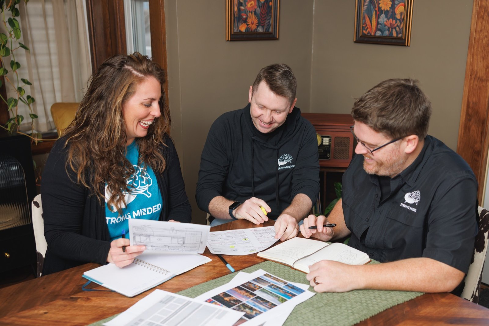 Strong Minded team reviewing printed documents together