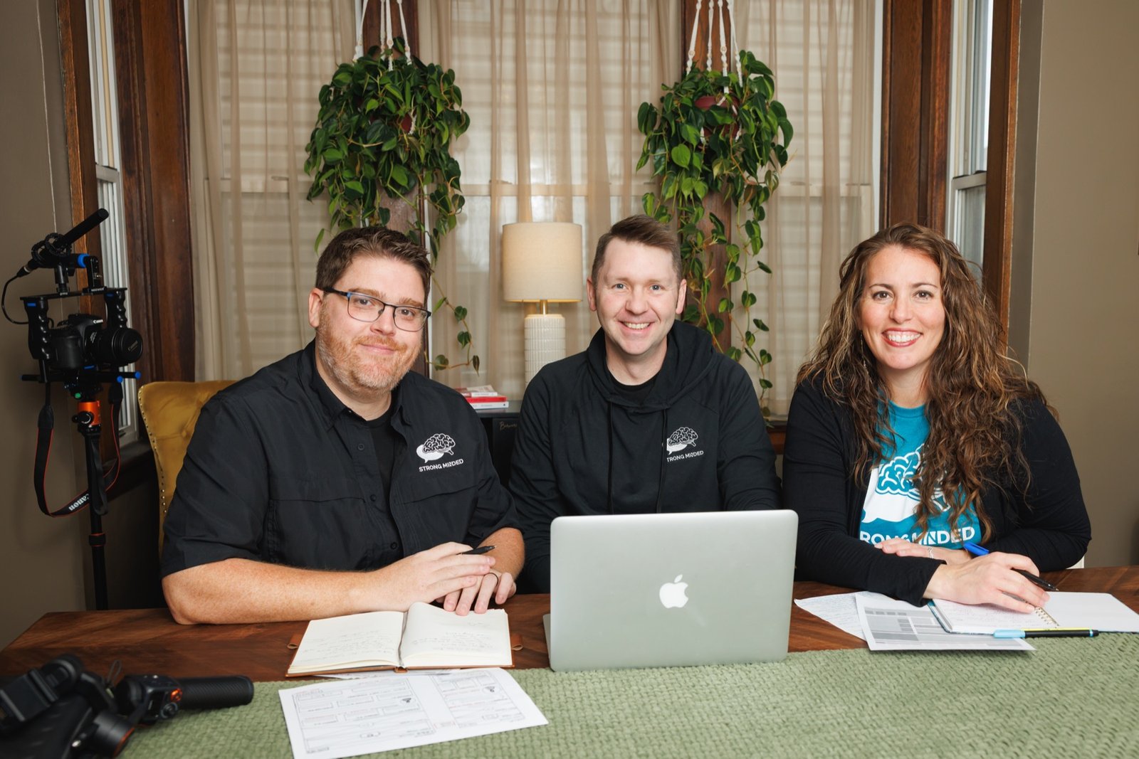 Strong Minded team gathered at a laptop